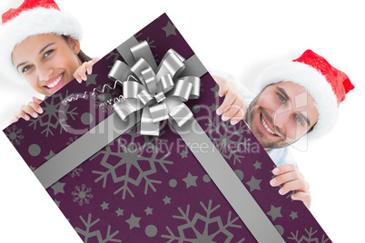 Composite image of festive young couple smiling at camera