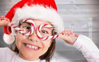 Composite image of festive little girl smiling at camera