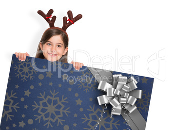 Composite image of festive little girl showing card