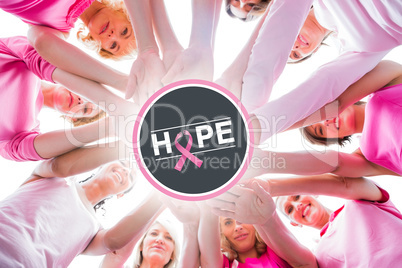 Composite image of diverse women smiling in circle wearing pink