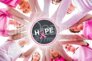 Composite image of diverse women smiling in circle wearing pink