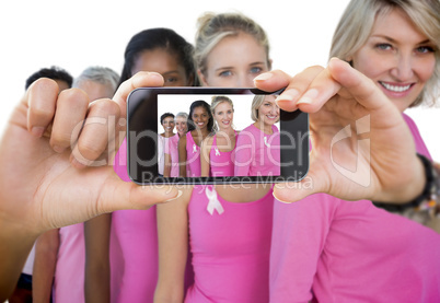 Composite image of hand holding smartphone showing