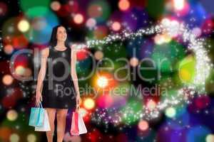 Composite image of woman walking with shopping bags