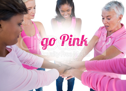 Women wearing pink and ribbons for breast cancer putting hands t