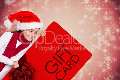 Composite image of festive little girl showing card