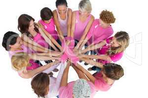 Composite image of cheerful women joined in a circle wearing pin