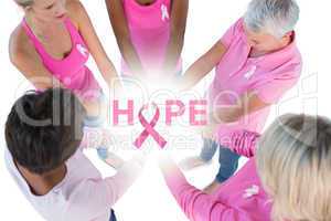 Composite image of group wearing pink and ribbons for breast can