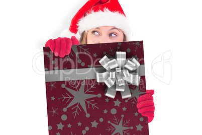 Composite image of festive blonde holding a poster