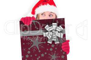 Composite image of festive blonde holding a poster