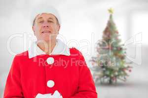 Composite image of festive man holding gift