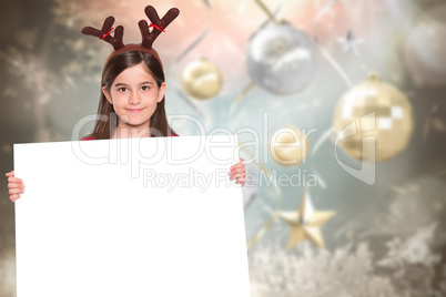 Composite image of festive little girl showing card Composite image of festive little girl showing card