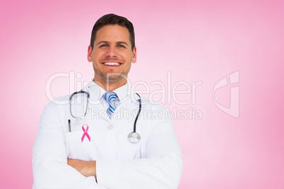Composite image of handsome doctor with arms crossed