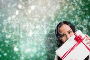 Composite image of woman holding a large present