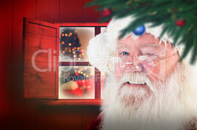 Composite image of santa claus winking