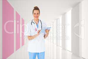 Composite image of pretty nurse using tablet pc