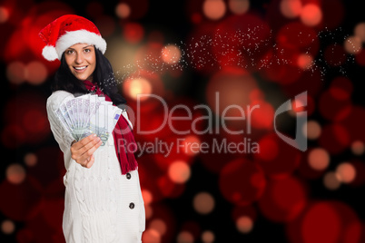 Composite image of woman holding money towards herself