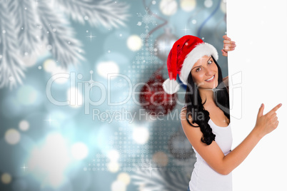 Composite image of woman pointing to large sign
