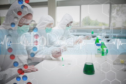 Composite image of three chemists working in protective suits
