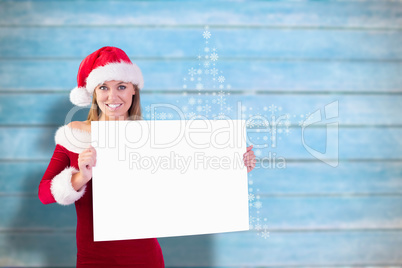 Composite image of festive blonde smiling at camera holding post