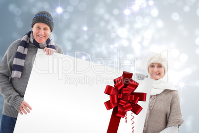 Winter couple showing a poster