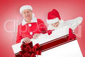 Composite image of festive couple showing poster