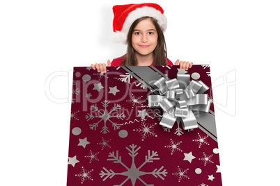 Composite image of festive little girl showing card