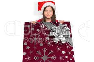 Composite image of festive little girl showing card