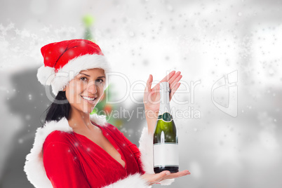 Composite image of woman holding a champagne bottle