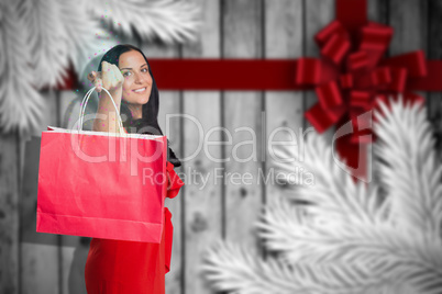 Composite image of woman standing with shopping bag