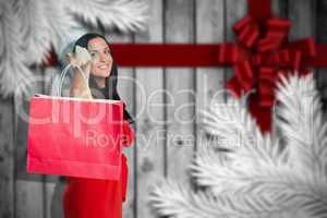 Composite image of woman standing with shopping bag