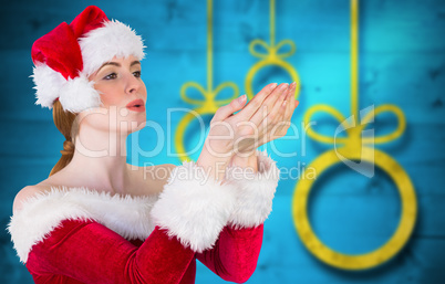 Composite image of pretty girl in santa costume holding hand out