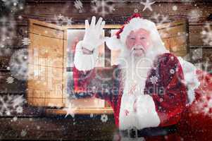 Composite image of santa claus waving