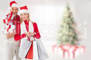 Composite image of happy festive couple with gifts and bags