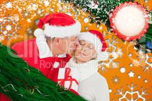 Composite image of festive mature couple holding gift