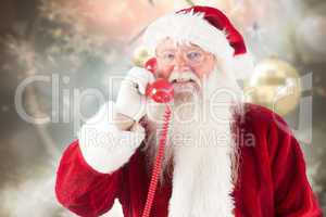 Composite image of santa claus on the phone