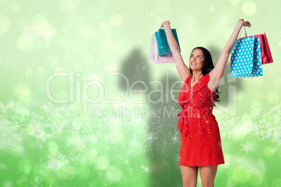 Composite image of woman standing with shopping bags