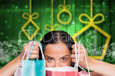 Composite image of woman standing with shopping bags