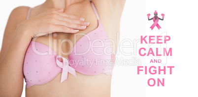 Composite image of woman in bra with breast cancer awareness rib