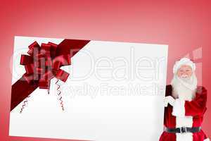 Santa claus showing card with ribbon