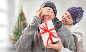 Composite image of mature woman surprising partner with gift