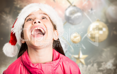 Composite image of festive little girl looking surprised