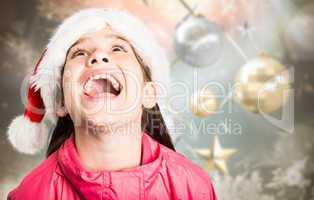 Composite image of festive little girl looking surprised