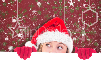 Composite image of festive blonde holding a poster