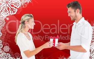 Composite image of young couple with gift