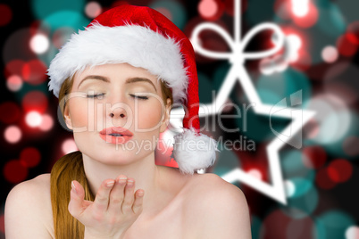 Composite image of sexy santa girl blowing a kiss