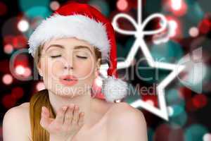 Composite image of sexy santa girl blowing a kiss