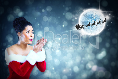 Composite image of pretty santa girl blowing over her hands