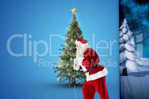 Composite image of santa claus pulling rope