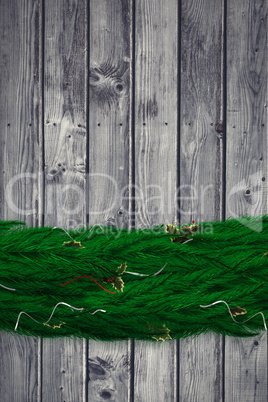 Composite image of fir branch christmas decoration garland