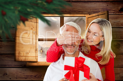 Composite image of loving couple with gift